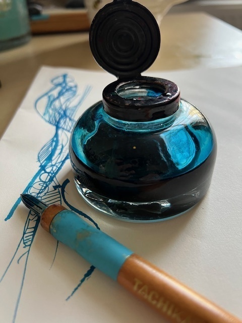 A photograph of an inkwell and dip pen and doodle in turqoise ink